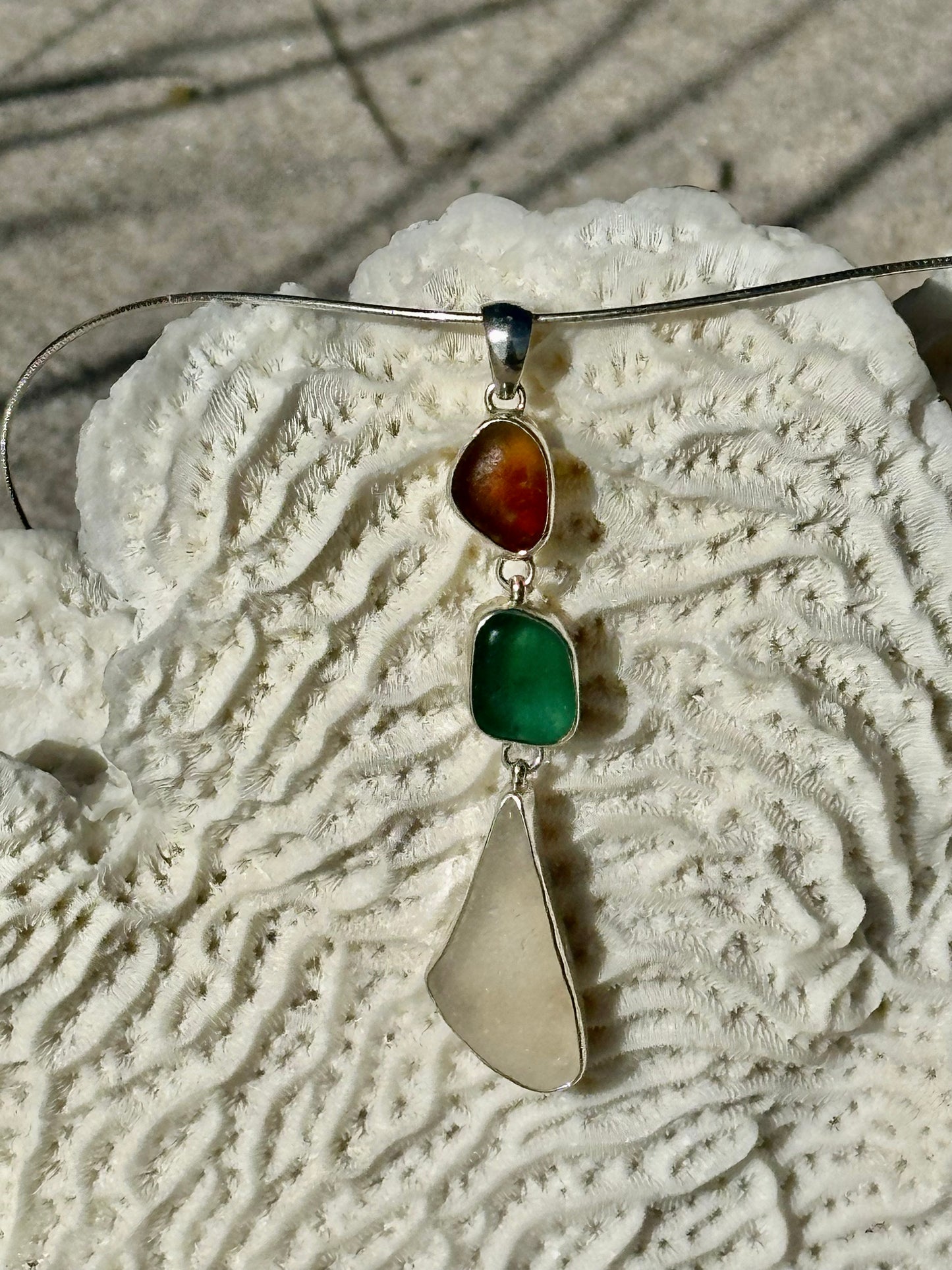 brown multi, teal, and white pendant
